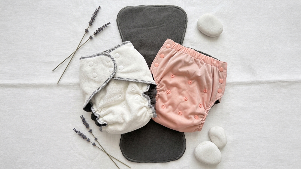 EcoAble cloth diaper system for special needs teens &mdash; folded and styled with calm, neutral aesthetics for teen incontinence and enuresis care