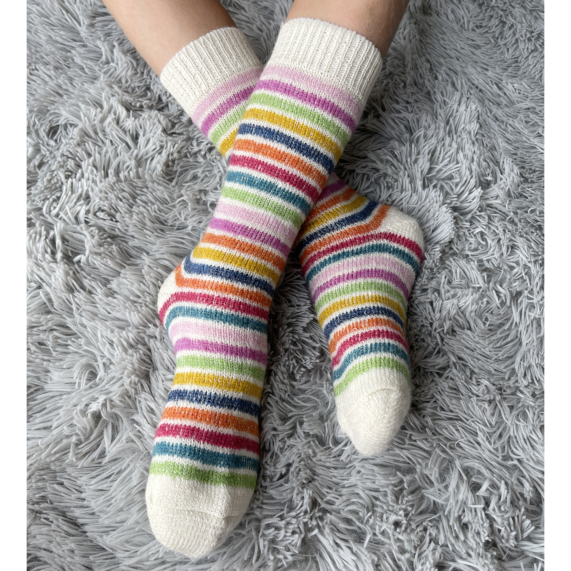 Child wearing Hirsch Natur 100% organic virgin wool socks in colorful stripes.