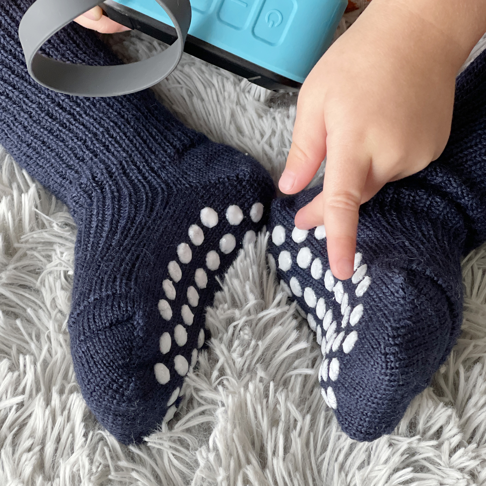 Kids playing indoors wearing Hirsch Natur wool socks with silicone grips for safe, non-slip traction.